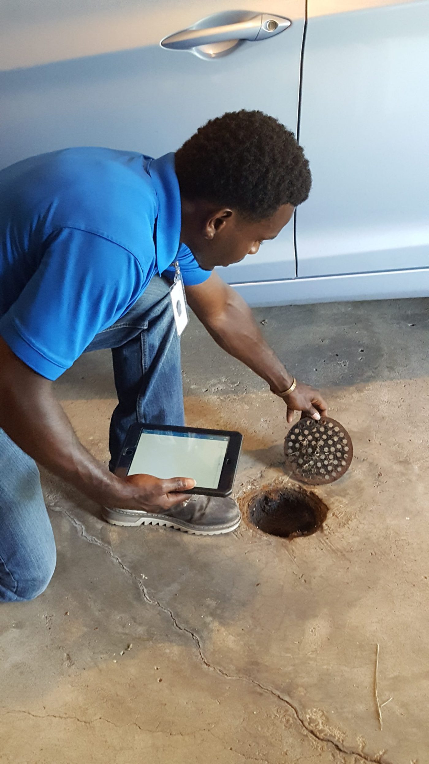 Inspector looking at drain inside home